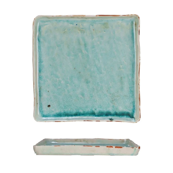 Rectangular ceramic dish with a textured turquoise glaze on a white background