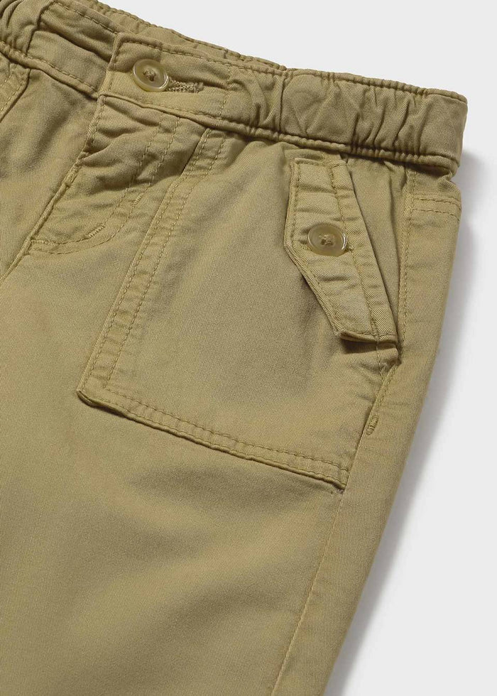 Closeup of Mayoral baby chinos showing cotton twill fabric, pocket detail, and adjustable waistband.
