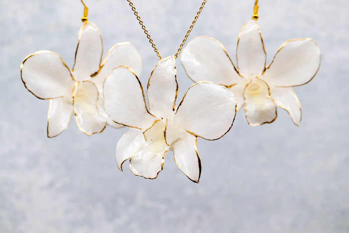 Landscape photo of a preserved orchid resin earring set with vibrant mixed dried flowers