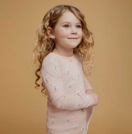 Girl wearing Petit Lem Light Pink flamingo pajamas with soft cotton comfort and long-sleeve top.