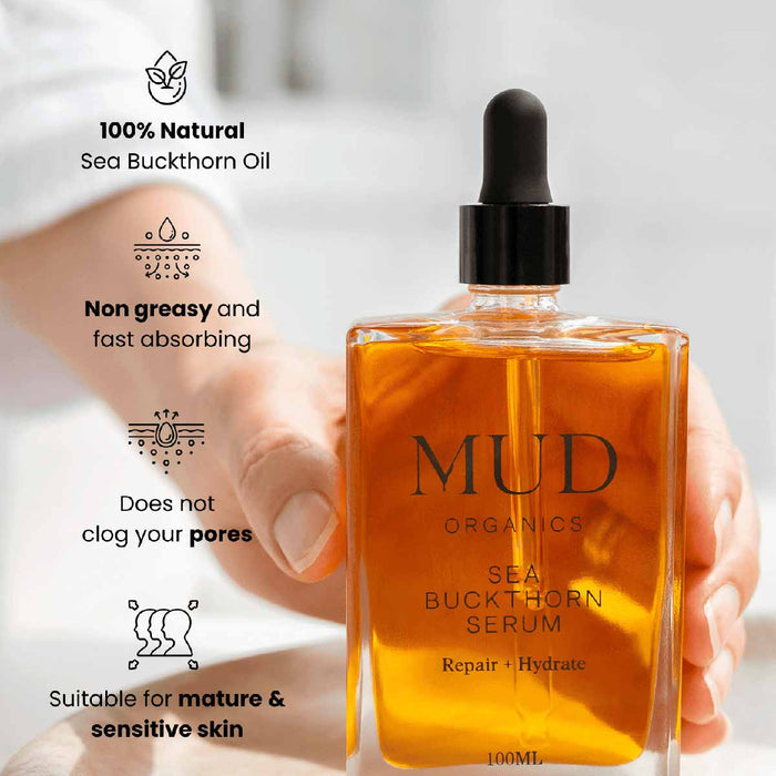 MUD Organics Sea Buckthorn Serum bottle held by a hand with product features listed.
