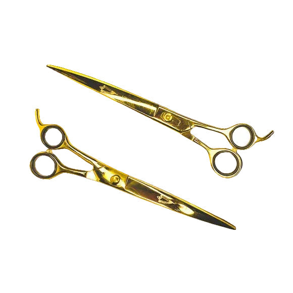 Pair of gold scissors on a white background