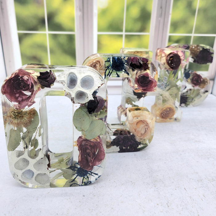 Square product photo of a pressed flower sympathy card holder with soft dried botanicals