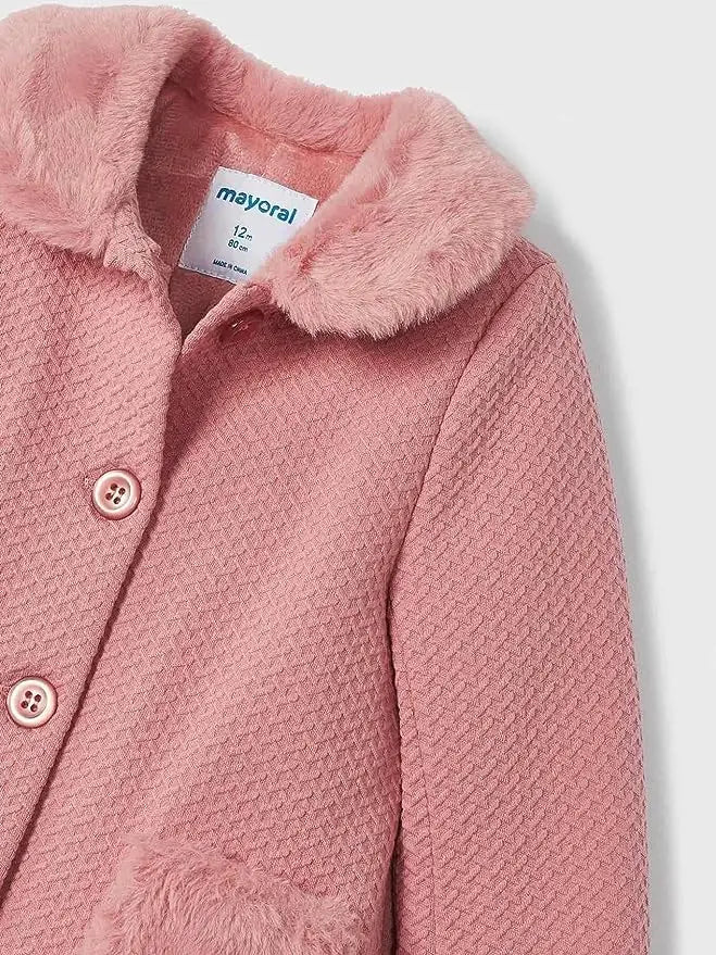 Close-up of Mayoral baby girl pink coat showing faux-fur collar, buttons, knit texture, and pocket detail.