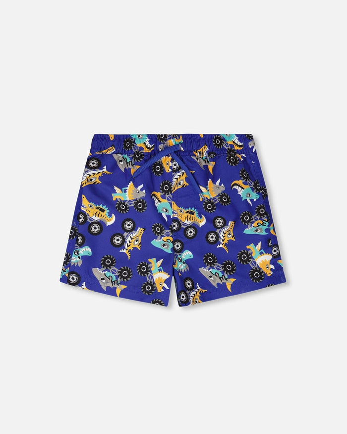 Front flat lay of Deux par Deux boy blue truck print boys swim trunks