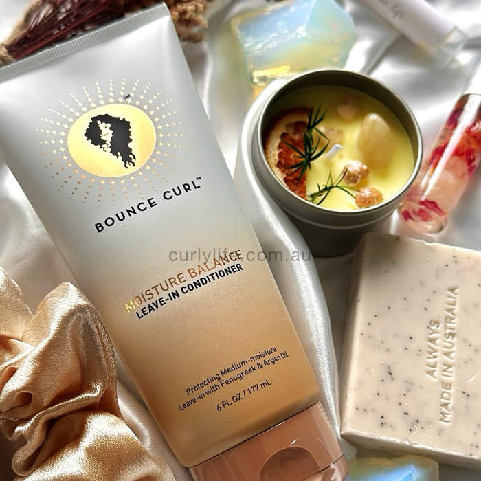 Bounce Curl Moisture Balance Leave-In Conditioner for curly hair with fenugreek & argan oil, styled with luxury bath items