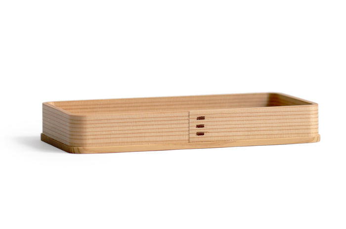 Silhouetted image of the rectangle cedar tray at an angle.
