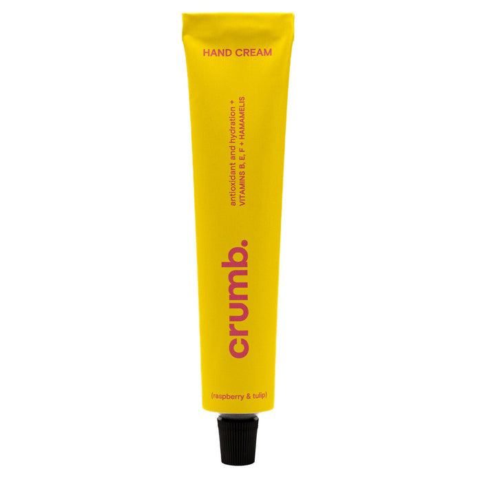 Yellow tube of crumb hand cream on a white background