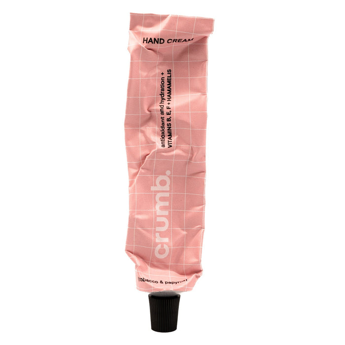 crumb pink hand cream tube tabacco & papyrus on a white background
