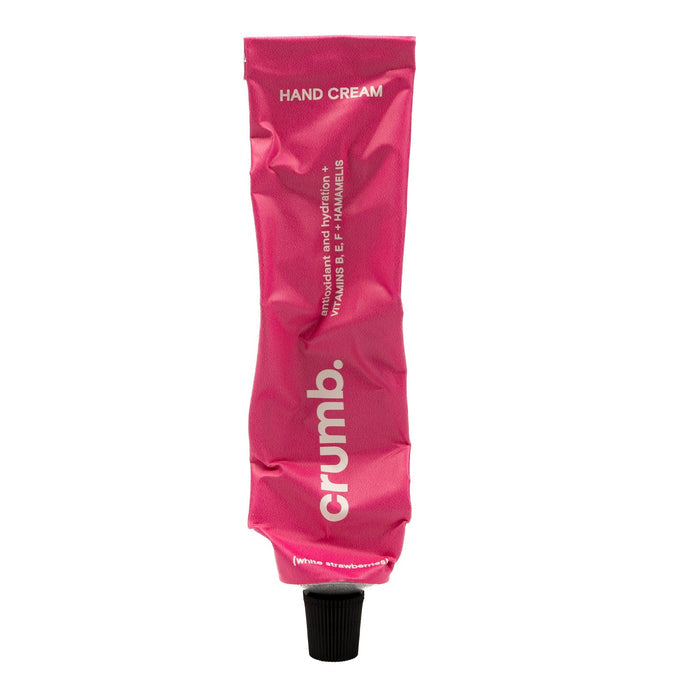 Crumb pink hand cream white strawberries tube on a white background