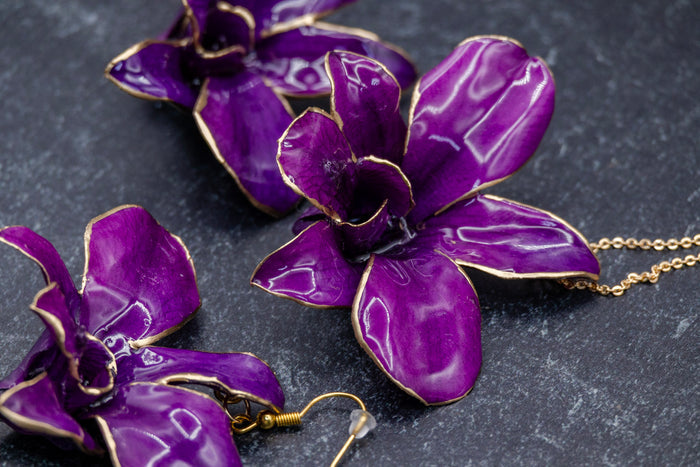 Landscape photo of a preserved orchid resin jewelry set with soft dried botanical layers