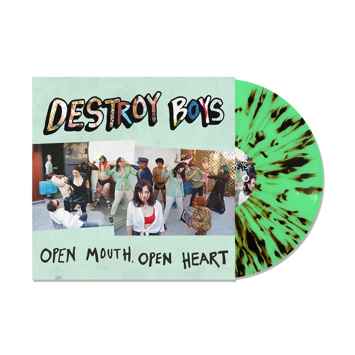 A green with black splatter Destroy Boys vinyl peeks from an “OPEN MOUTH, OPEN HEART” album cover, showing a casual indoor group scene. Pre-order now to reveal the full tracklisting.
