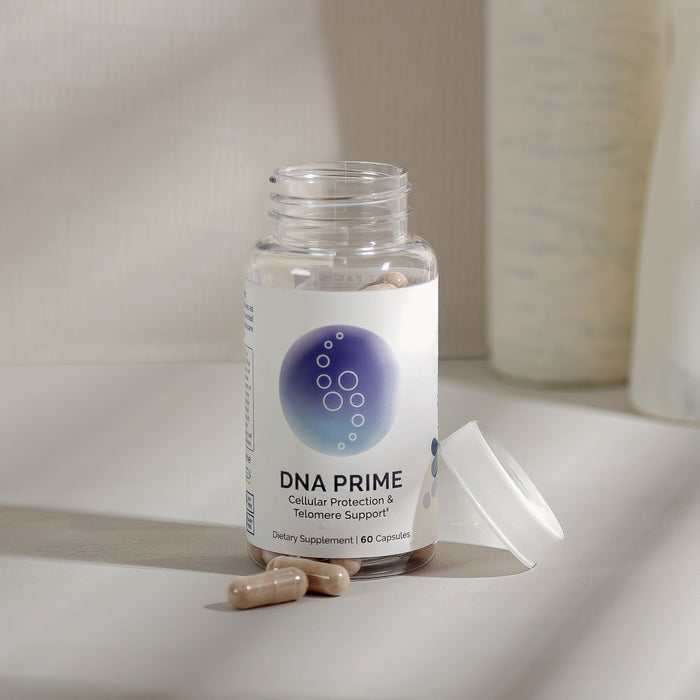 InfiniWell DNA PRIME dietary supplement bottle with capsules, white lid removed, 60 capsules.