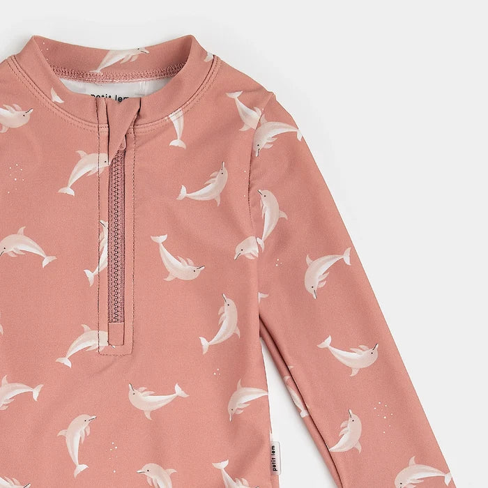 Close-up of Wild Rose Petit Lem long-sleeve swimsuit with white dolphin print and frilled leg openings