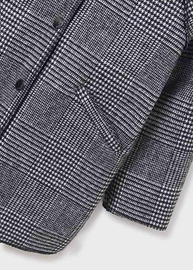 Close-up of Mayoral girls plaid coat showing black gray pattern, pocket detail, and sleeve finish.