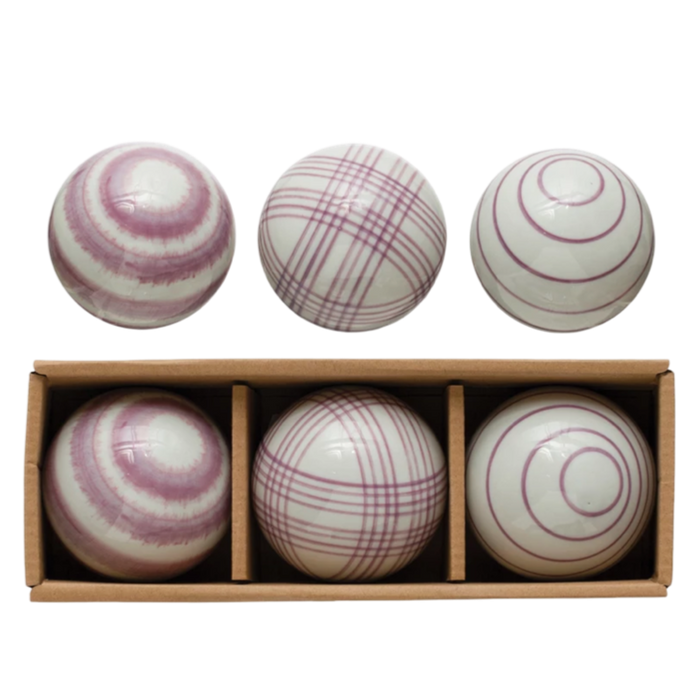 Set of six striped balls in a wooden box on a white background