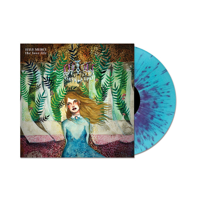 A translucent blue and purple splatter vinyl by Have Mercy, partially in its album cover featuring an illustrated woman in a blue dress amid green plants, with the love life written in the top left corner.