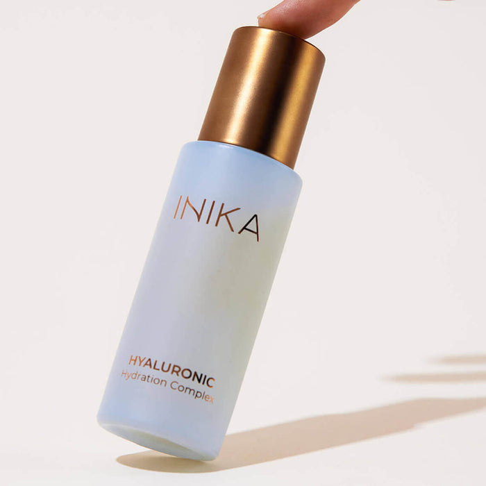 Dropper bottle of certified organic Hyaluronic Hydration Complex leaning on a side.