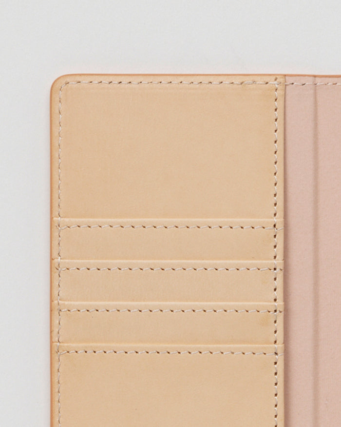 Close-up of open iPhone Case by Hender Scheme of card slots on a gray background.