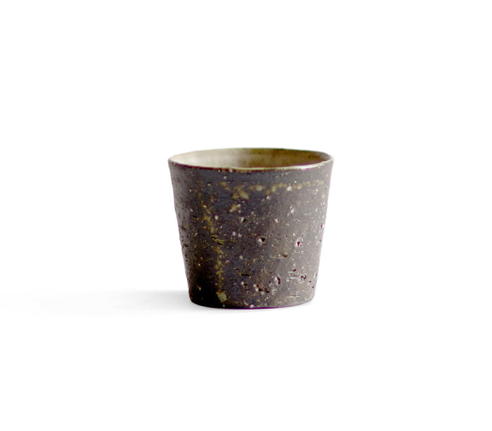 A brown textured cup against white background.