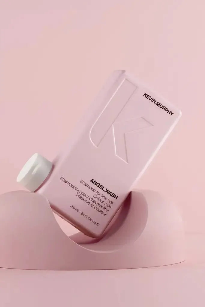 Kevin Murphy Angel Wash shampoo bottle on a pink background - Hair Care Canada