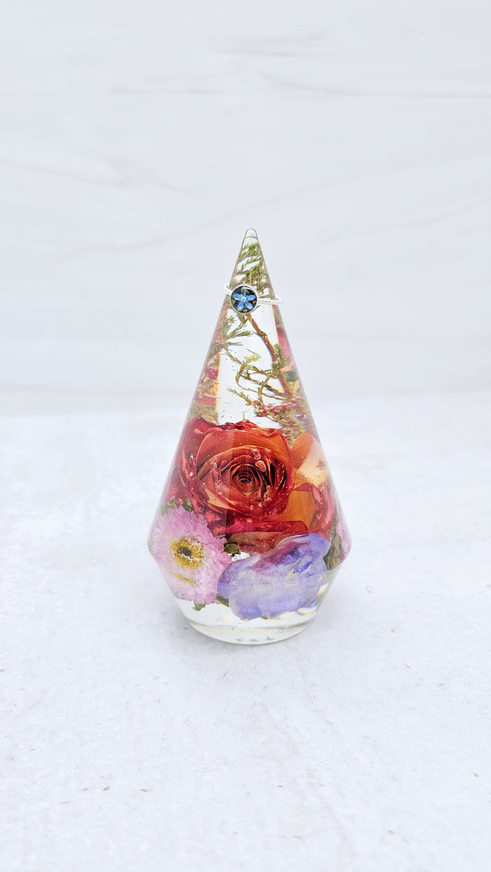 Close-up of large preserved flower ring holder showing dried bouquet detail in resin