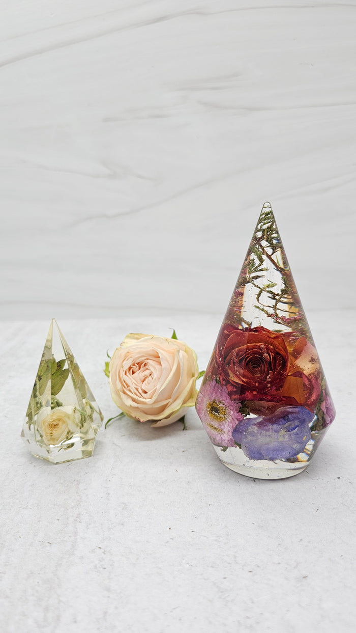 Tall portrait photo of a large pressed flower ring holder with blush dried roses in resin