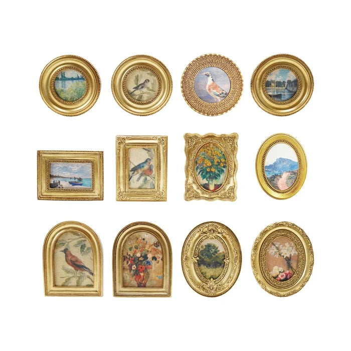 Collection of gold-framed pictures with various scenes on a white background
