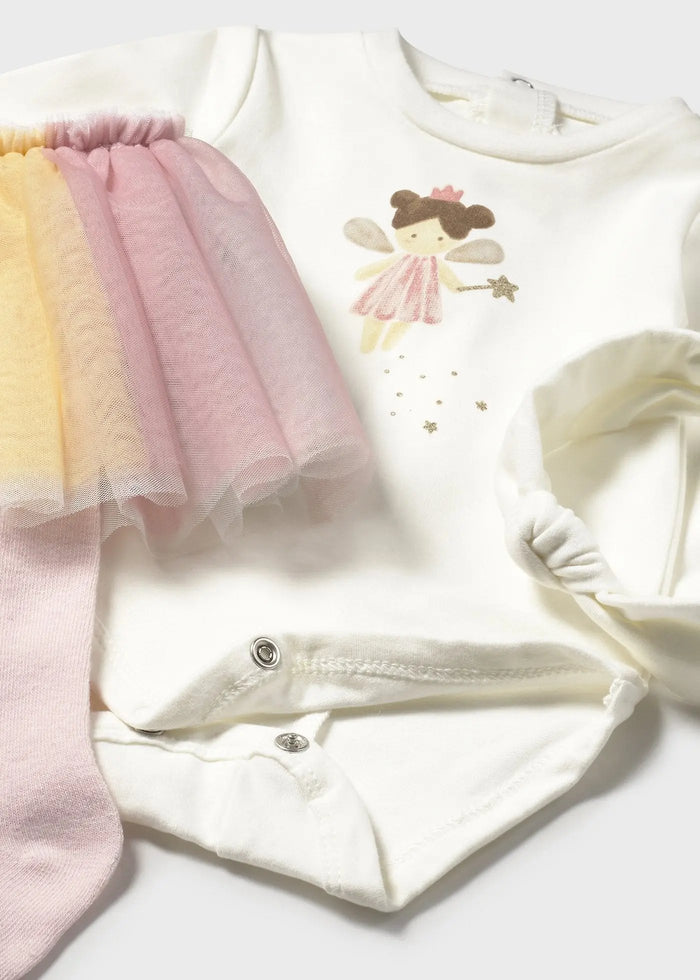 Flat lay of bodysuit, skirted tights, and matching headband — coordinated set for photos and outings.