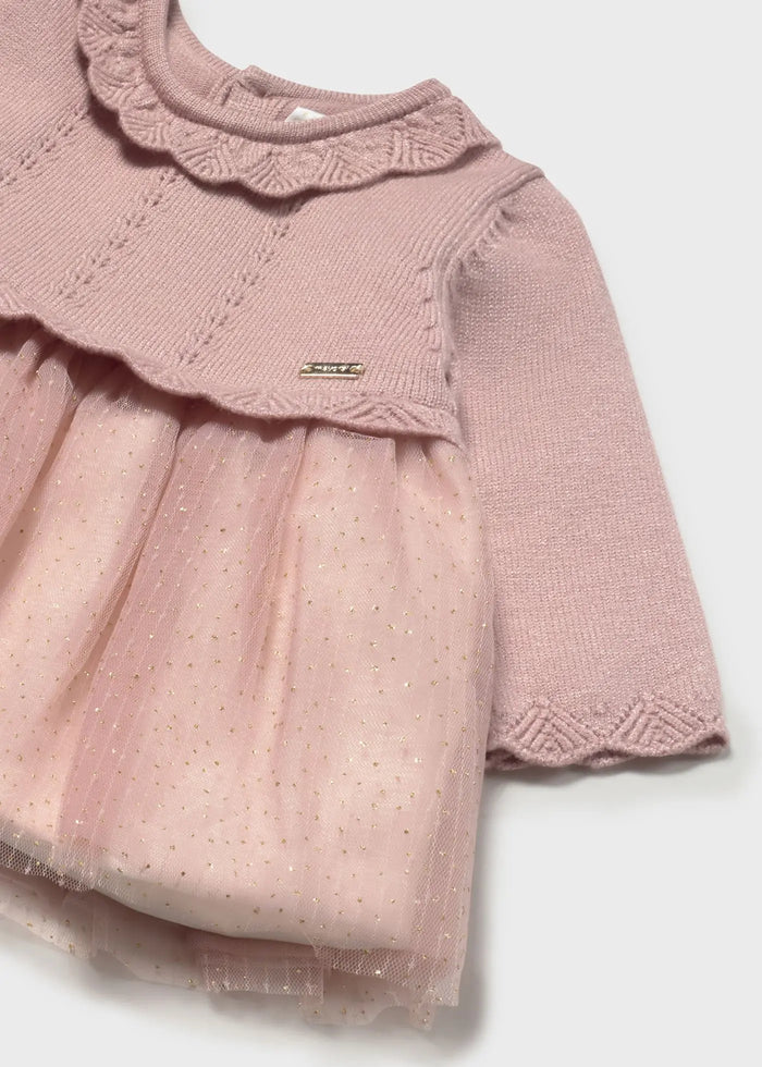 Lifestyle photo showing side angle of Mayoral newborn dress