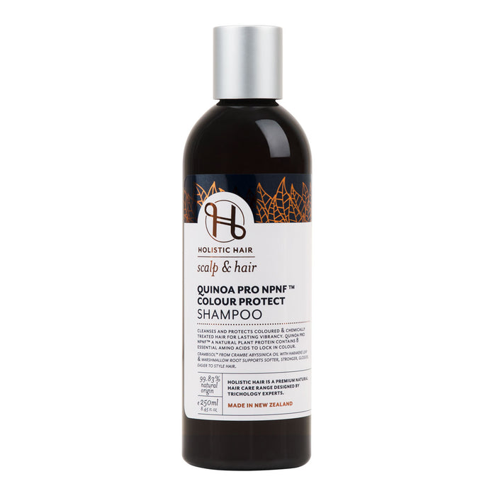 A bottle of Holistic Hair Quinoa Pro NPNF Colour Protect Shampoo with a label showing details about the product.