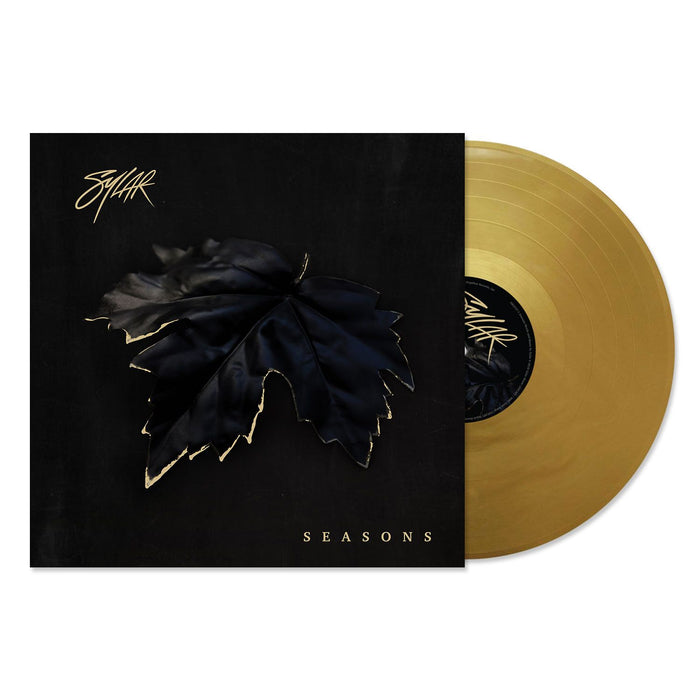 A gold vinyl record slides from a black cover featuring a dark leaf with gold edges, evoking winter. The cover shows the brand name “Sylar” and the title “SEASONS” in white lettering.