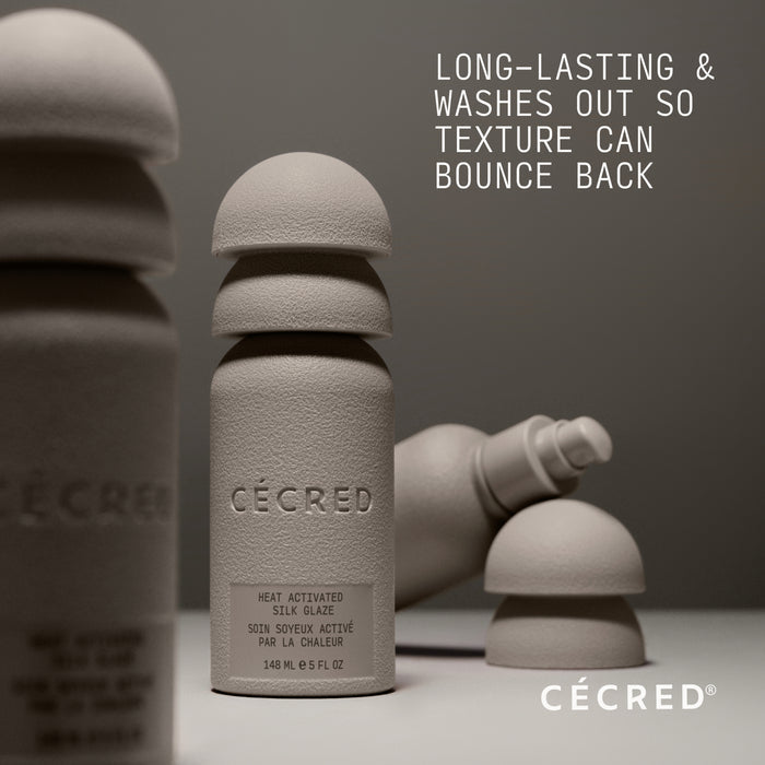 Cécred Heat Activated Silk Glaze bottle with text on a gray background saying "Long-lasting & washes out so texture can bounce back"