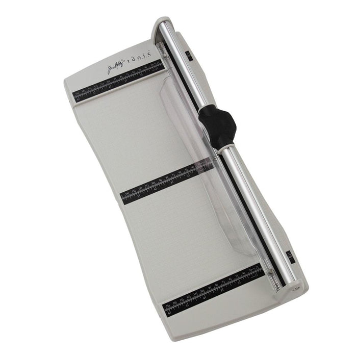 Tim Holtz - Rotary Media Trimmer. Featuring a geared rotary cutting blade, this trimmer effortlessly cuts through a range of crafting mediums. Available at Embellish Away located in Bowmanville Ontario Canada.