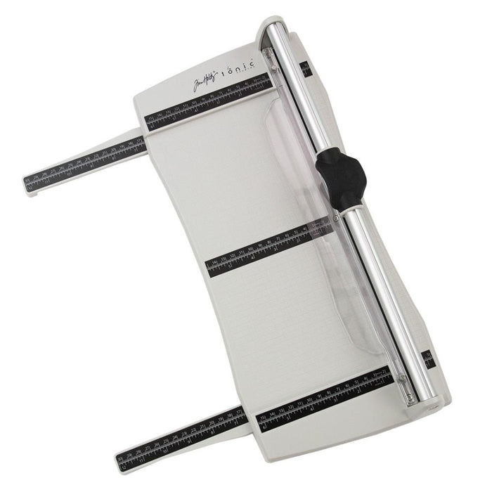 Tim Holtz - Rotary Media Trimmer. Featuring a geared rotary cutting blade, this trimmer effortlessly cuts through a range of crafting mediums. Available at Embellish Away located in Bowmanville Ontario Canada.