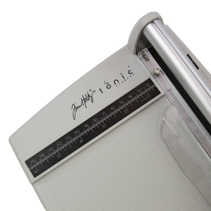 Tim Holtz - Rotary Media Trimmer. Featuring a geared rotary cutting blade, this trimmer effortlessly cuts through a range of crafting mediums. Available at Embellish Away located in Bowmanville Ontario Canada.