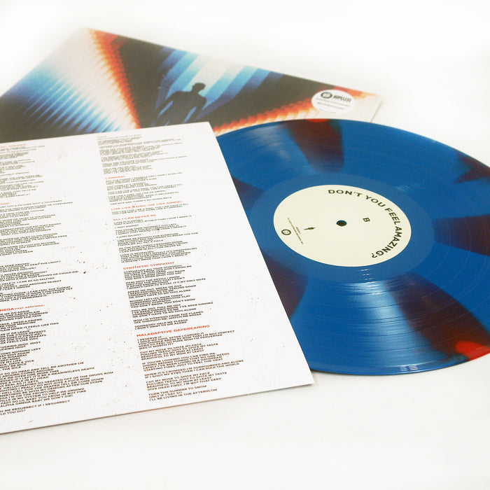 A Limited Edition blue vinyl record by Trash Boat, with its tracklist on a printed lyrics sheet and an album cover featuring a silhouette against a colorful geometric background, are displayed on a white surface.