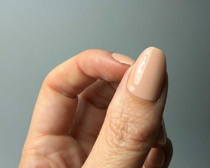 Peaches N Cream UV-Free gel nail wraps worn on the hand, close-up